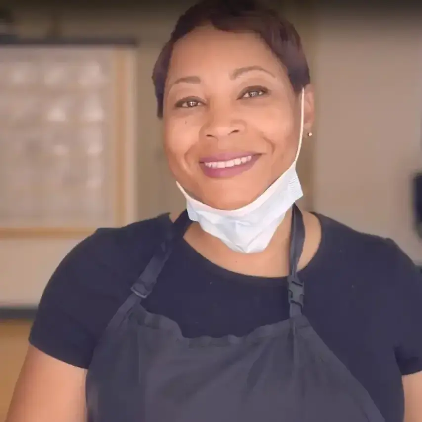Natausha of Divine Designs smiling in her work apron