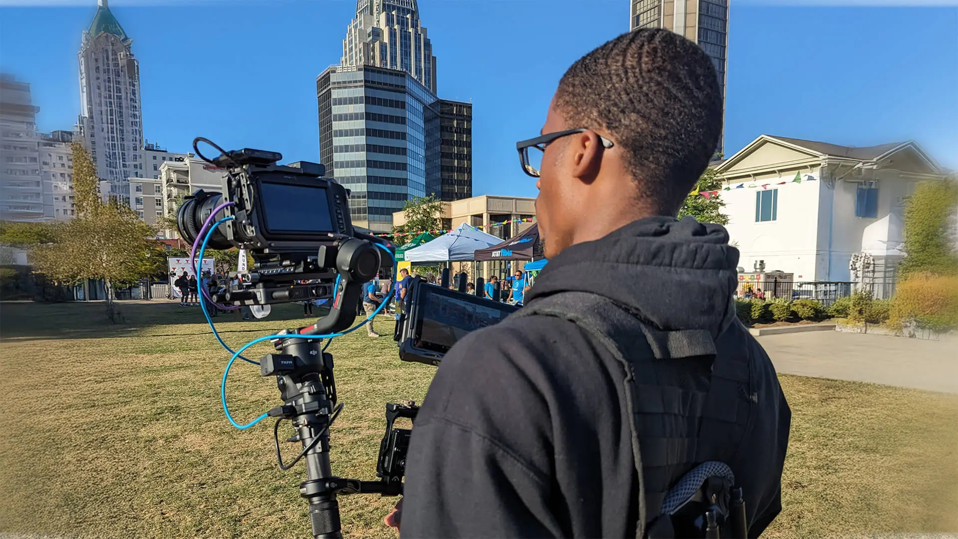 AVO Dynamics videographer filming an outdoor event in downtown Mobile with a gimbal-mounted cinema camera
